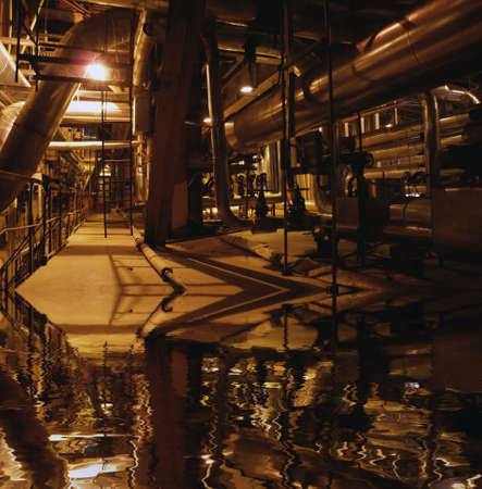 an assortment of different size and shaped pipes at a power plantの写真素材