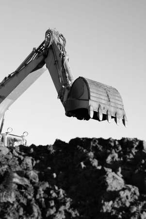 Hydraulic excavator at work. Shovel bucket against sky        の写真素材