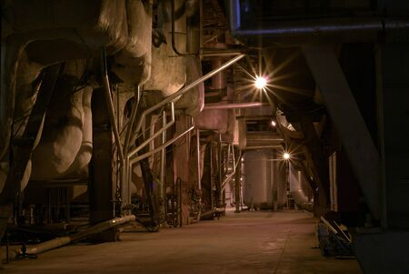 an assortment of different size and shaped pipes at a power plant の写真素材