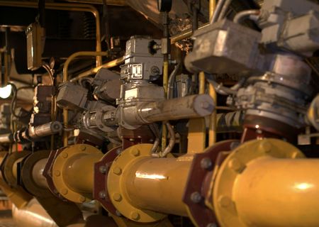 Equipment, cables and piping as found inside of a modern industrial power plant 