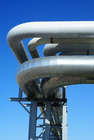 industrial pipelines on pipe-bridge against blue sky