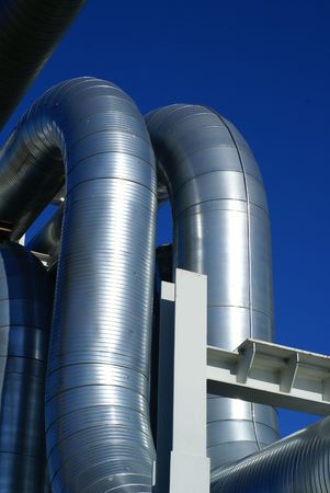 industrial pipelines on pipe-bridge against blue sky            