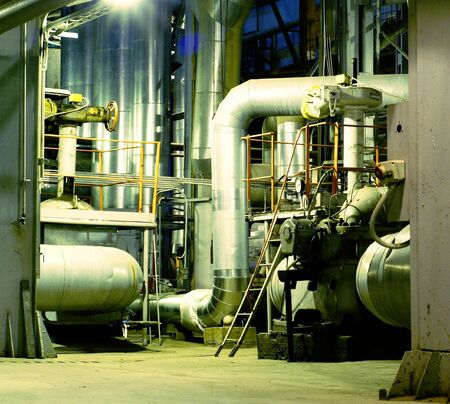Pipes, tubes, machinery and steam turbine at a power plant          