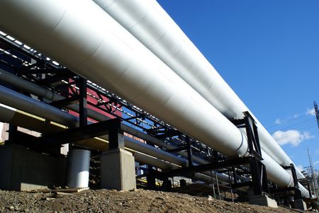 industrial pipelines on pipe-bridge against blue sky                 
