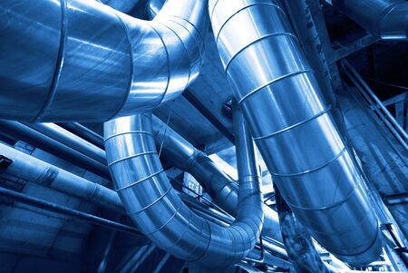 Equipment, cables and piping as found inside of a modern industrial power plant                