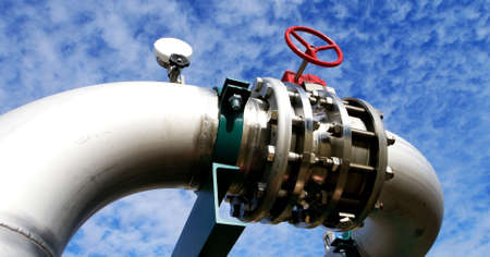 Industrial zone, Steel pipelines and valves against blue sky