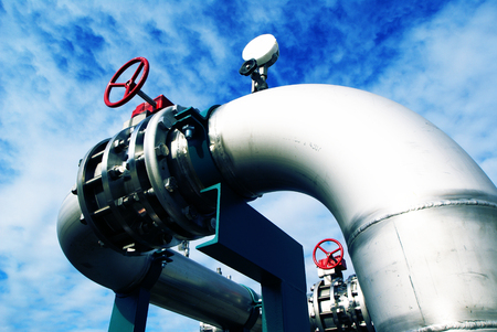 Industrial zone, Steel pipelines and valves against blue skyの写真素材
