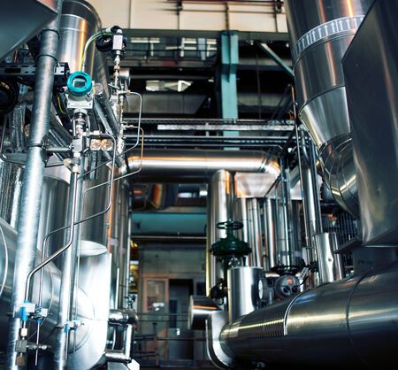 Equipment, cables and piping as found inside of a modern industrial power plant