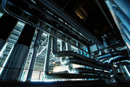 Equipment, cables and piping as found inside of a modern industrial power plant