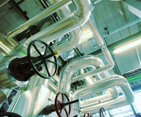 Equipment, cables and piping as found inside of a old industrial power plantの写真素材