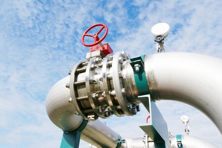 Industrial zone, Steel pipelines and valves against blue sky