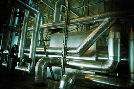 Equipment, cables and piping as found inside of a industrial power plant