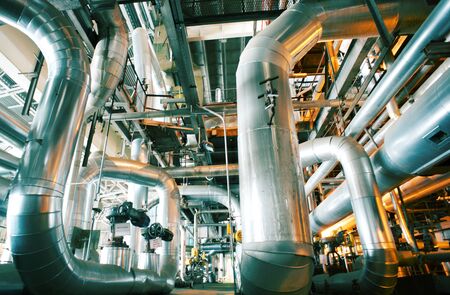 Equipment, cables and piping as found inside of a industrial power plant