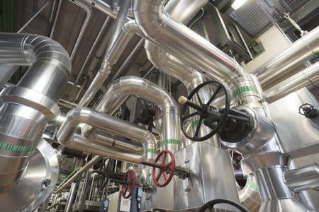 different size and shaped pipes and valves at a power plantのeditorial素材