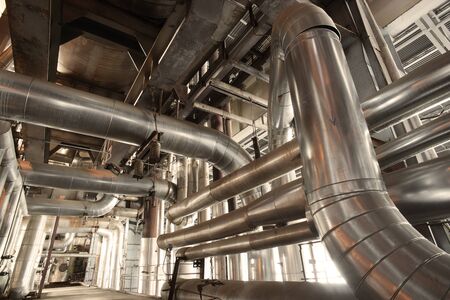 different size and shaped pipes and valves at a power plantのeditorial素材