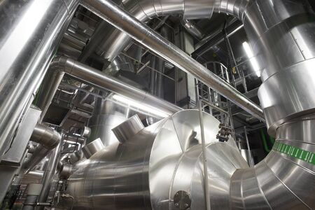 different size and shaped pipes and valves at a power plantのeditorial素材