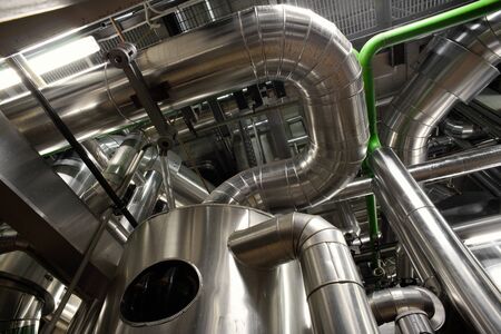 different size and shaped pipes and valves at a power plantのeditorial素材