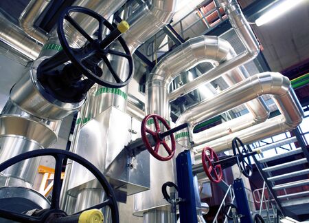 Equipment, cables and piping as found inside of a modern industrial power plant