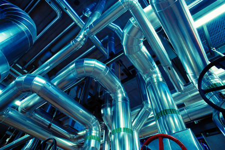 Equipment, cables and piping as found inside of a modern industrial power plant