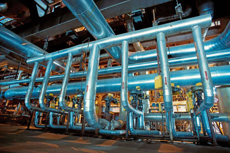 Equipment, cables and piping as found inside of a modern industrial power plant