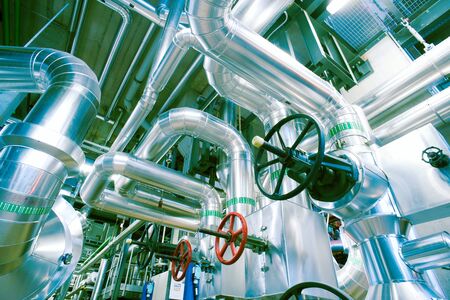 Equipment, cables and piping as found inside of a modern industrial power plant