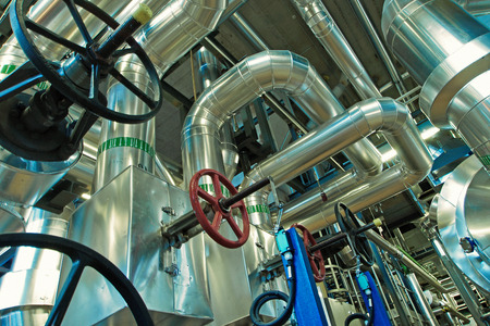equipment, cables and piping as found inside of a modern industrial power plant