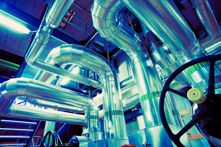 different size and shaped pipes and valves at a power plantの写真素材