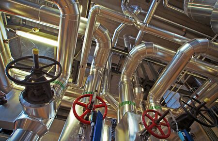 Equipment, cables and piping as found inside of a industrial power plant