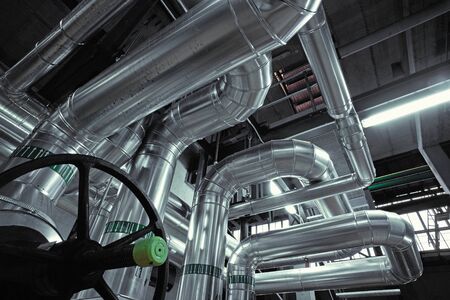Equipment, cables and piping as found inside of a modern industrial power plant