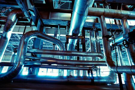 Equipment, cables and piping as found inside of a modern industrial power plant