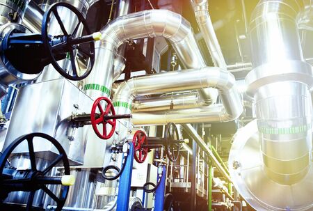 Equipment, cables and piping as found inside of a modern industrial power plant