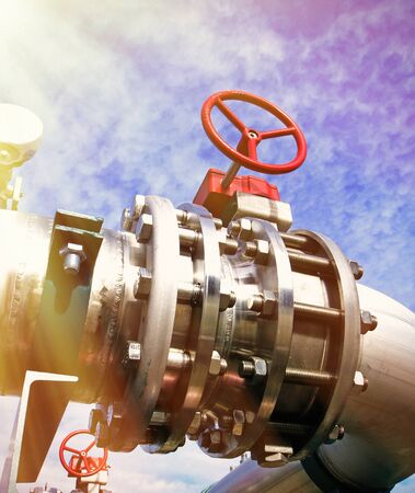 Industrial zone, Steel pipelines and valves against blue skyの写真素材