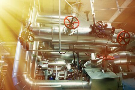 Equipment, cables and piping as found inside of a modern industrial power plant