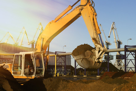 Hydraulic excavator at work. Shovel bucket and cranes against blue skyの写真素材