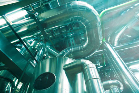 Equipment, cables and piping as found inside of a modern industrial power plant