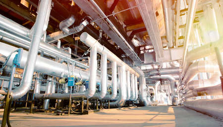 Equipment, cables and piping as found inside of a old industrial power plant