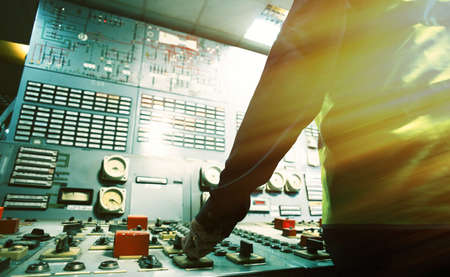 operator hand on the control panel power plantの写真素材