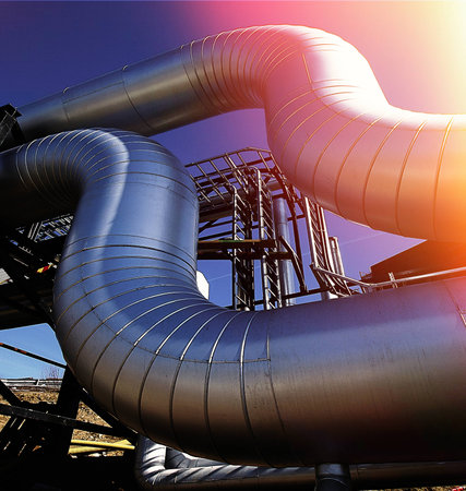 Industrial zone, Steel pipelines and valves against blue sky