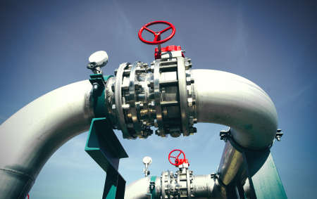 Industrial zone, Steel pipelines and valves against blue sky