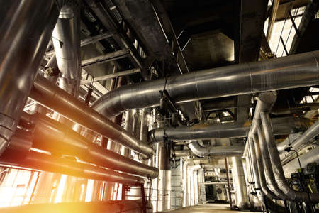 Equipment, cables and piping as found inside of a modern industrial power plant