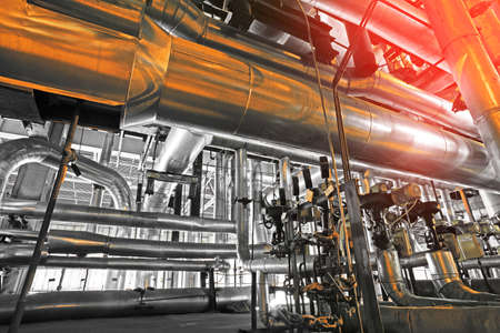 Equipment, cables and piping as found inside of a modern industrial power plant