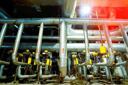 Equipment, cables and piping as found inside of a modern industrial power plant