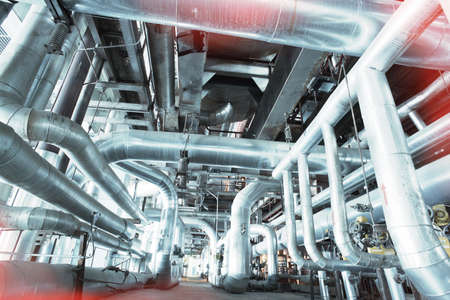 Equipment, cables and piping as found inside of a modern industrial power plant