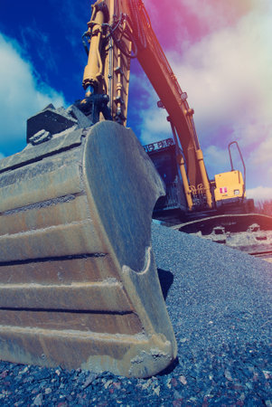 excavator against blue sky