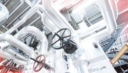 Equipment, cables and piping as found inside of a industrial power plant
