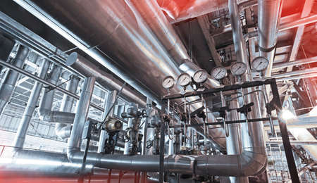 Equipment, cables and piping as found inside of a modern industrial power plant