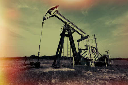 Industrial zone, oil jack against sky