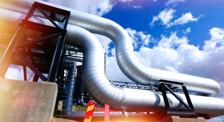 Industrial zone, Steel pipelines and valves against blue sky