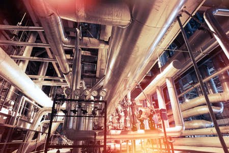 Equipment, cables and piping as found inside of a modern industrial power plant    