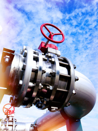 Industrial zone, Steel pipelines and valves against blue sky
